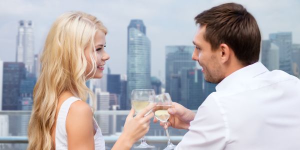 A couple toasting in a balcony
