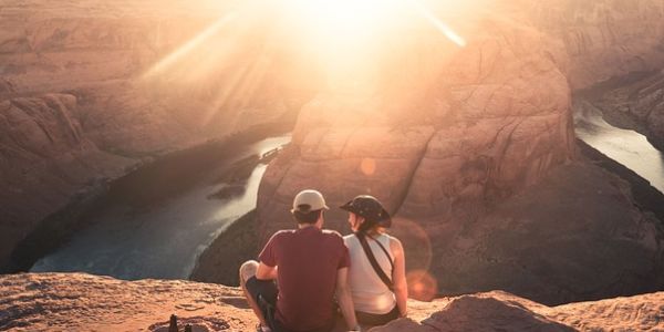 Couple with backs to viewer watching the grand canyon