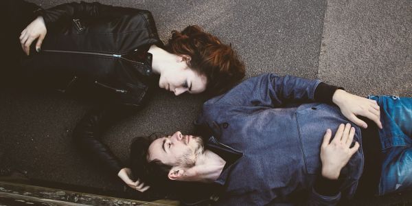 Couple lying down facing each other