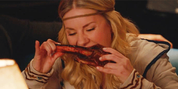 Woman eating ribs with her hands